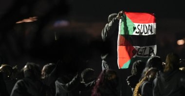 An attendee holds flags during halftime of the NFL Super Bowl 59 football game between the Kansas City Chiefs and the Philadelphia Eagles, New Orleans, U.S., Feb. 9, 2025. (AP Photo)