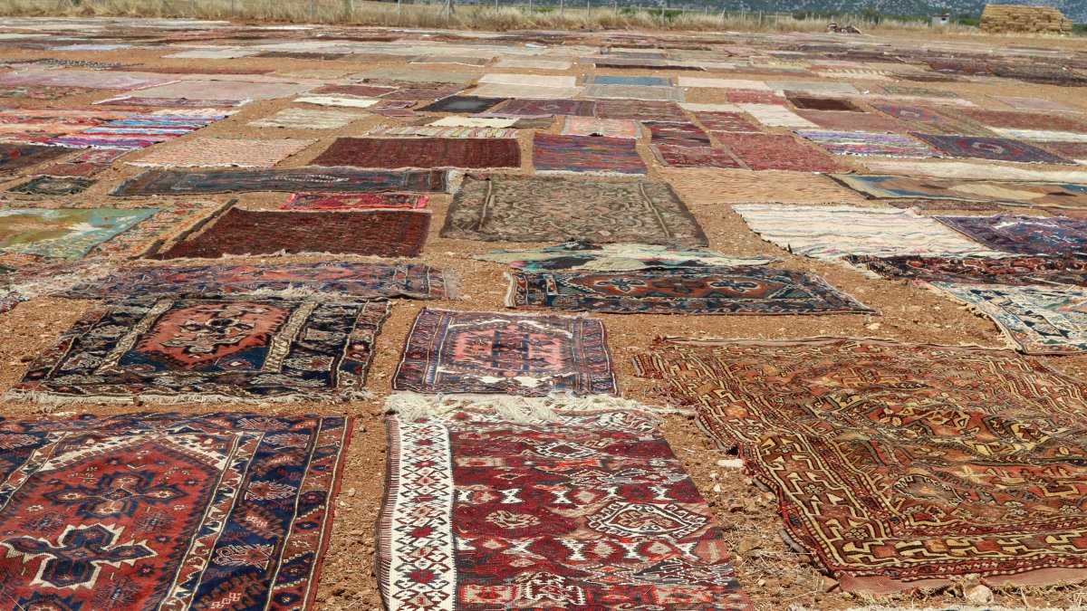 Rows of handwoven carpets dry and fade under the intense summer sun, Antalya, Türkiye, June 29, 2025. (DHA Photo)