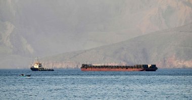 A tug boat tows a barge off the coast of Khasab, on northern Oman’s Musandam Peninsula overlooking the Strait of Hormuz, Oman, June 24, 2025. (AFP Photo)
