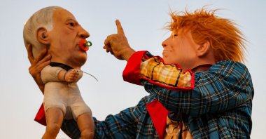A demonstrator in a costume of U.S. President Donald Trump holds a baby puppet depicting Israel&#039;s Prime Minister Benjamin Netanyahu during an anti-government protest, Tel Aviv, Israel, June 28, 2025. (AFP Photo)