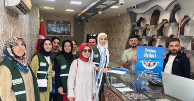 A Green Crescent Counseling Center (YEDAM) team raises addiction awareness by distributing brochures and engaging with shopkeepers, Şanlıurfa, Türkiye, June 26, 2025. (AA Photo)