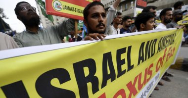 Supporters of the Islamic political party Jamiat Ulema-e-Islam (JUI-F) in Pakistan hold a banner that reads &quot;Israel and America – Nexus of Evil&quot; during a rally to show solidarity with Iran, Karachi, Pakistan, June 23, 2025. (EPA Photo)