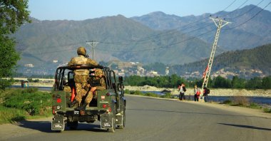 Pakistani soldiers with rifles on a military vehicle in Swat, Khyber Pakhtunkhwa, Pakistan, April 13, 2016. (Shutterstock Photo)