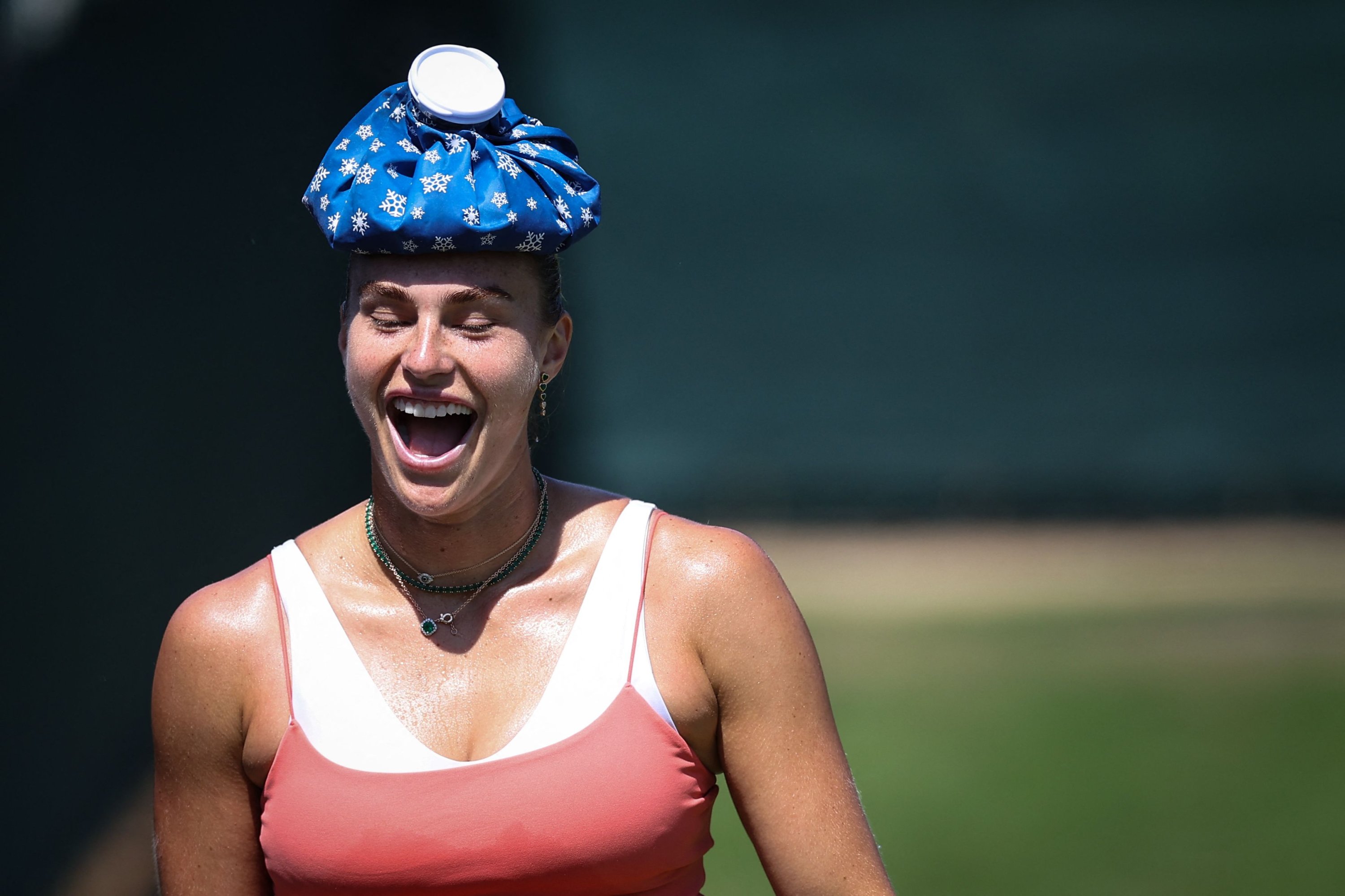 Belarus's Aryna Sabalenka reacts as she walks with an ice pack on her head to cool down during a training session during the 2025 Wimbledon Championships at the All England Lawn Tennis and Croquet Club, London, U.K., June 29, 2025. (AFP Photo)