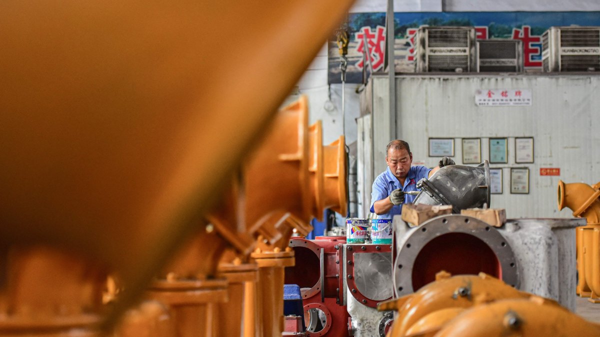 An employee works on a water pump production line at a factory, Qingzhou, China, June 30, 2025. (AFP Photo)
