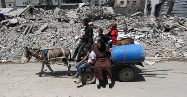 A Palestinian family flees their home with their belongings after the Israeli army issued evacuation orders, Gaza, Palestine, June 29, 2025. (Reuters Photo)