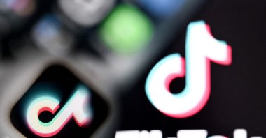 Chinese social networking service TikTok&#039;s logos are seen on a smartphone and laptop screens in Frankfurt, Germany, April 10, 2025. (AFP Photo)