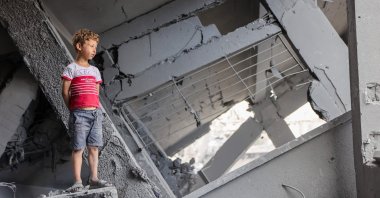 A Palestinian boy stands amidst the rubble of Yaffa School in the Tuffah neighbourhood following overnight Israeli strikes, Gaza City, central Gaza, Palestine, June 30, 2025. (AFP Photo)