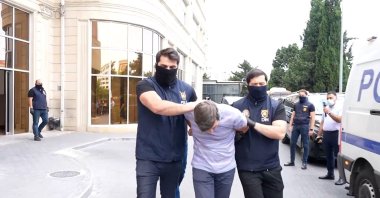 Azerbaijani security forces escort a Russian suspect detained as part of the operation, Baku, June 30, 2025. (AA Photo)