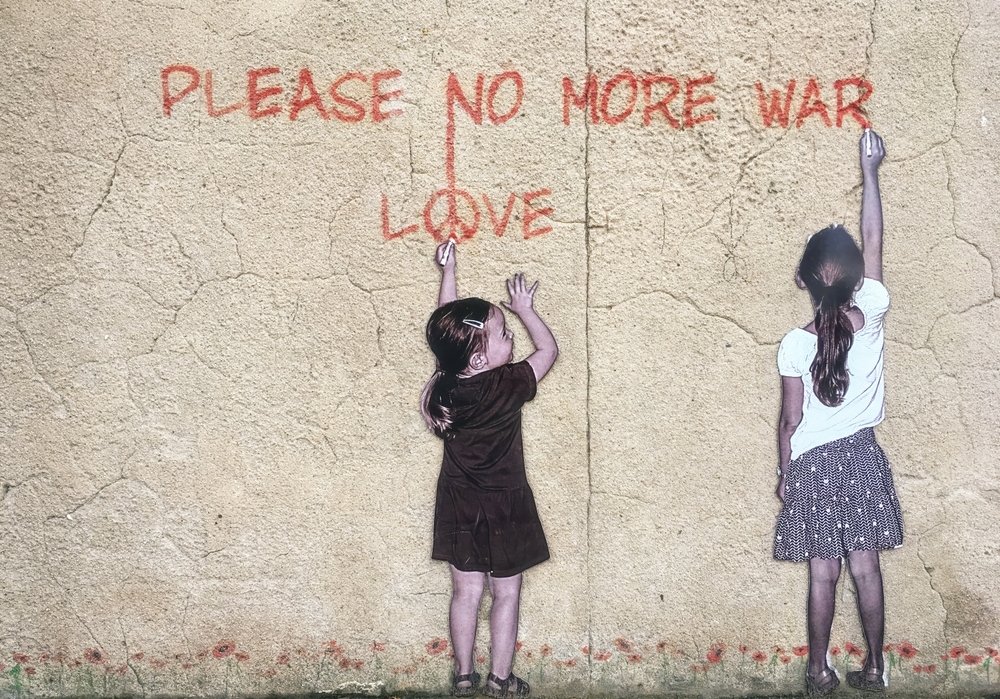 Street art in Banksy’s style shows two girls writing