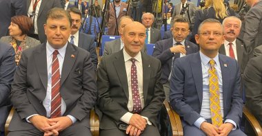 Tunç Soyer (C) sits next to his successor Cemil Tugay (L) and CHP Chair Özgür Özel (R) at an event, Izmir, western, Türkiye, March 14, 2024. (İHA Photo)