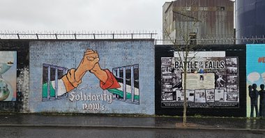 A striking mural showcasing solidarity with Palestine alongside a historical panel commemorating the &quot;Battle of the Falls&quot; from 1970, Belfast, Northern Ireland, Jan. 12, 2025. (Shutterstock Photo)