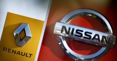 The logos of car manufacturers Renault and Nissan are seen in front of dealerships of the companies, Saint-Nazaire, France, Feb. 6, 2023. (Reuters Photo)