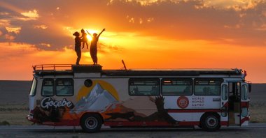 The Duran family poses atop their caravan, named “Nomad,” at a location in Central Asia, June 30, 2025. (AA Photo)