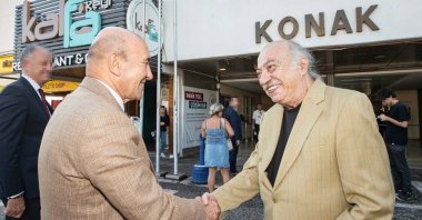 This undated photo shows former Mayor Tunç Soyer shaking hands with actor Yücel Erten, who was also detained in Tuesday's operations, Türkiye. (DHA Photo)