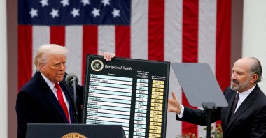 U.S. President Donald Trump holds a chart next to U.S. Secretary of Commerce Howard Lutnick as Trump delivers remarks on tariffs in the Rose Garden at the White House, Washington, U.S., April 2, 2025. (Reuters Photo)