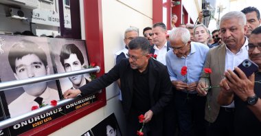 People leave flowers near photos of the victims outside the hotel torched in 1993, Sivas, central Türkiye, July 2, 2025. (AA Photo)