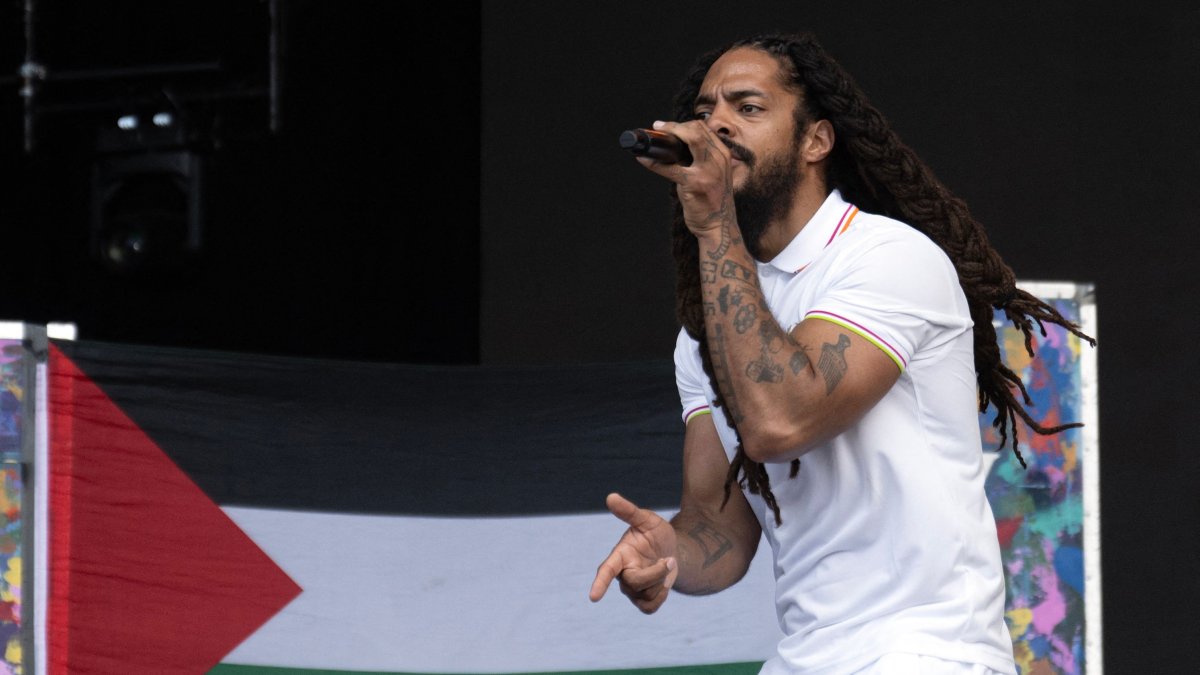 To the backdrop of a Palestinian flag, Bobby Vylan of British duo Bob Vylan performs on the West Holts Stage on the fourth day of the Glastonbury festival at Worthy Farm, village of Pilton, Somerset, southwest England, June 28, 2025. (AFP Photo)