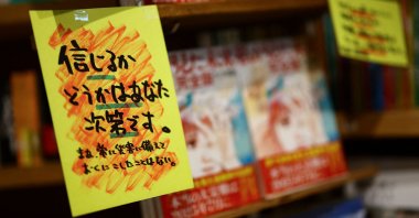 A sales banner written by the store reading &quot;Whether you believe it or not is up to you&quot; is displayed next to the comic book titled &quot;The Future I Saw,&quot; authored by manga artist Ryo Tatsuki, on the shelf at the book store Village Vanguard, Tokyo, Japan, June 30, 2025. (Reuters Photo)