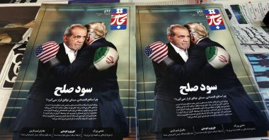 Copies of the Iranian magazine Tejarat Farda, titled &#039;The benefit of peace,&#039; feature an image of Iranian President Masoud Pezeshkian and U.S. President Donald Trump embracing while wearing boxing gloves at a kiosk in Tehran, Iran, June 3, 2025. (EPA Photo)