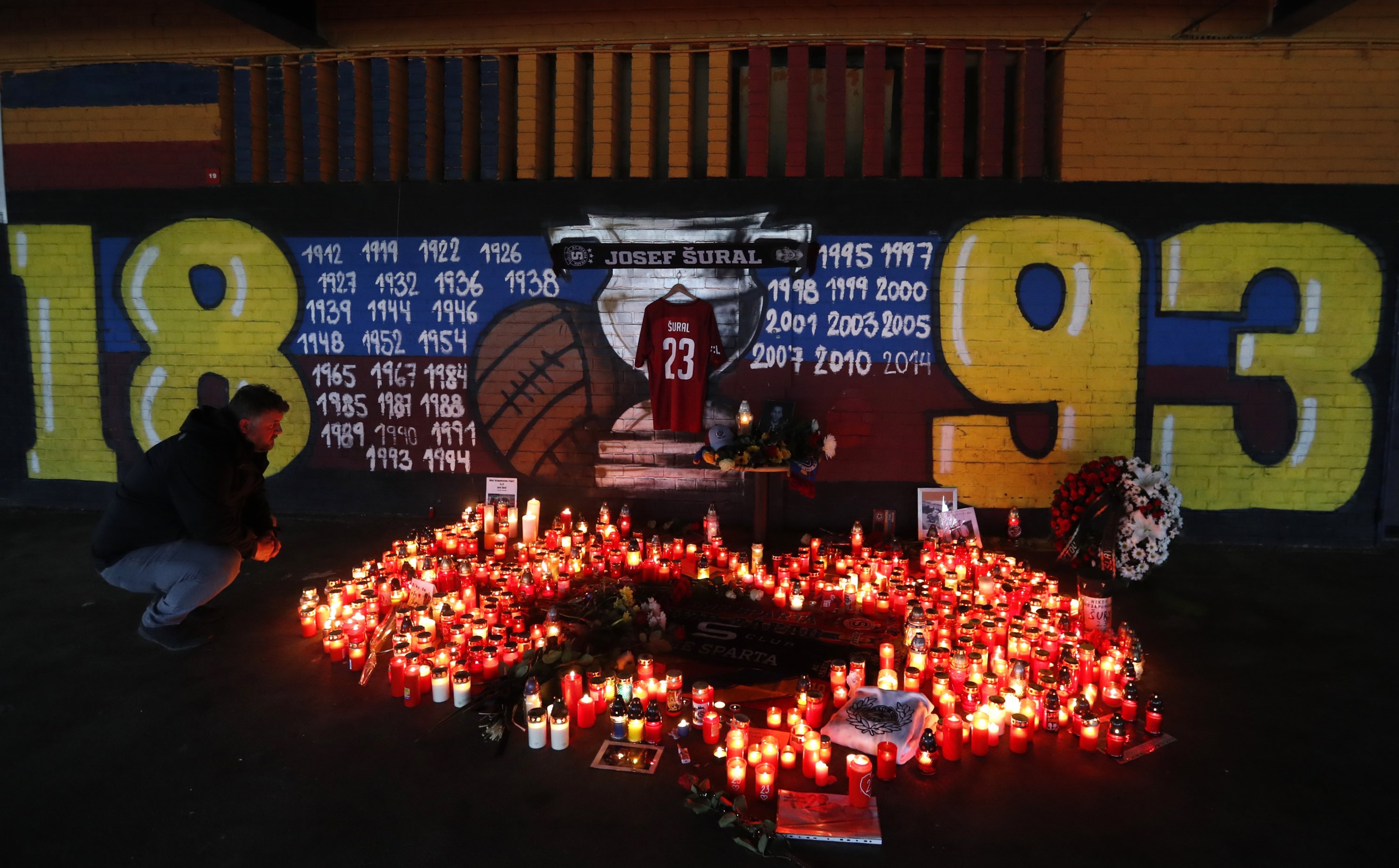 A man looks at candles placed near the Sparta stadium after the death of Czech player Josef Sural, Prague, Czechia, April 29, 2019. (AP Photo)
