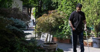 Orthopedic specialist Dr. Ali Alnweiri works on standing again after his physical therapy, Ankara, Türkiye, June 26, 2025. (AA Photo)