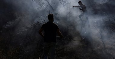 Men try to extinguish a wildfire at the village of Agia Fotini near Ierapetra, Crete, Greece, July 3, 2025. (Reuters Photo)