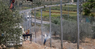 Workers construct a fence, which was ordered by Israeli authorities, in Sinjil, occupied West Bank, Palestine, May 5, 2025. (Reuters Photo)
