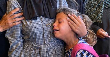 A Palestinian girl is comforted by a relative as she mourns a loved one during the funeral of Palestinians killed in Israeli strikes on the southern Gaza Strip the previous day, outside the Nasser Hospital, Khan Younis, Gaza Strip, Palestine, July 4, 2025. (AFP Photo)