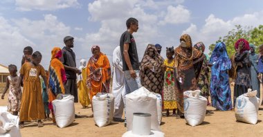 This June 2023 photo provided by the World Food Program shows food distribution by the WFP for internally displaced persons at the Wad Almajzoub farm camp, Wad Medani, Sudan, Aug. 6, 2023. (AP Photo)
