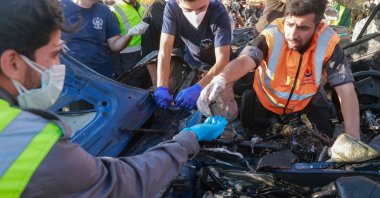 Lebanese emergency responders inspect the debris at the site of a reported Israeli strike on a vehicle in Khaldeh, Beirut, Lebanon, July 3, 2025. (AFP Photo)