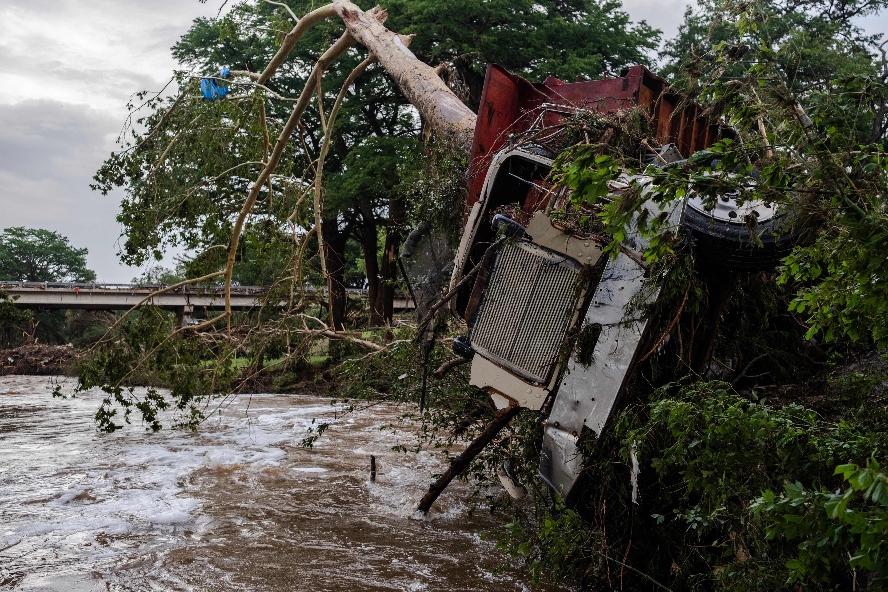 A large truck is impaled onto a tree after flash flooding on the bank Guadalupe River, in Center Point, Texas, July 5, 2025. (AFP Photo)