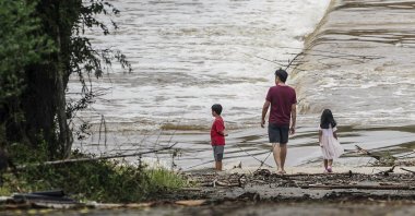 People watch the Guadalupe River flow over a bridge in Kerrville, Texas, U.S. July 5, 2025. (EPA Photo)