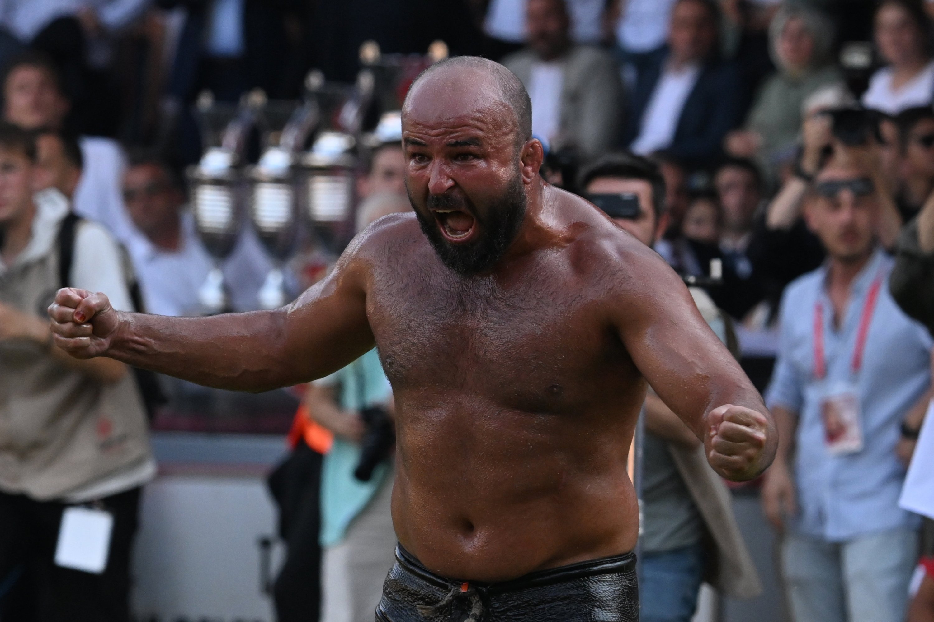 Orhan Okulu celebrates after beating Feyzullah Aktürk to claim his third title at the 664th Kırkpınar Oil Wrestling Festival, Edirne, Türkiye, July 6, 2025. (AA Photo)