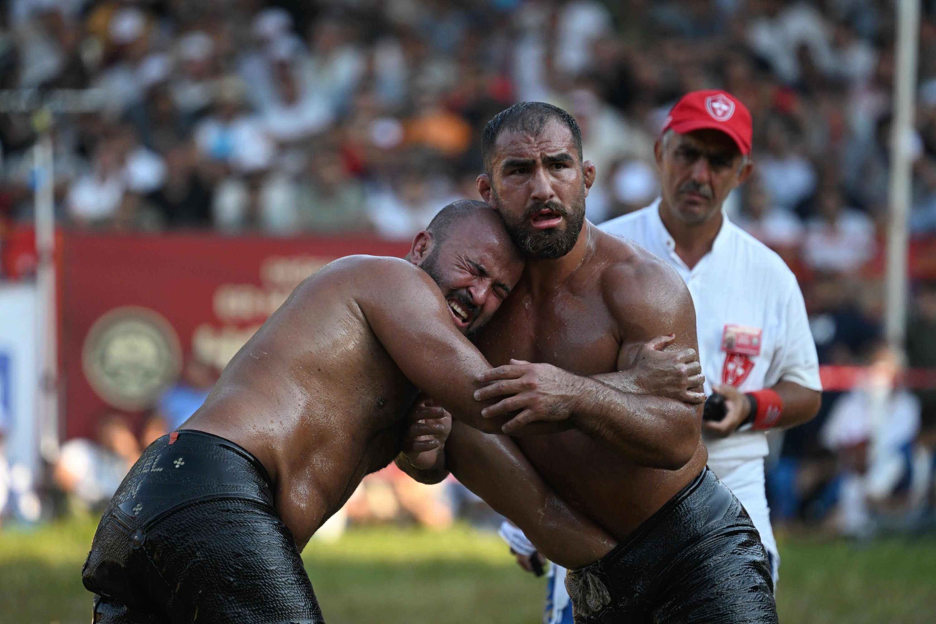 Orhan Okulu (L) in action with Feyzullah Aktürk at the 664th Kırkpınar Oil Wrestling Festival, Edirne, Türkiye, July 6, 2025. (AA Photo)