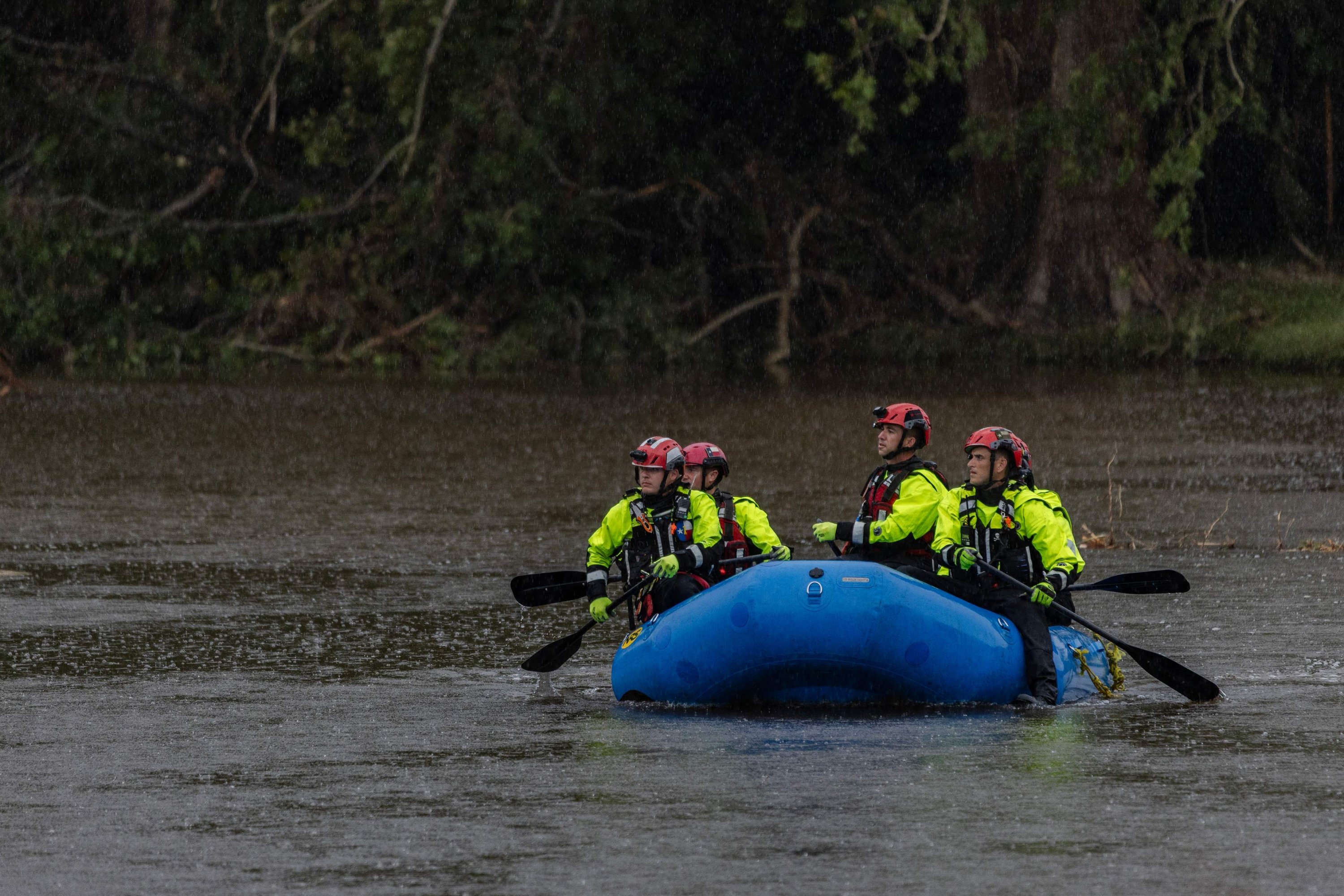 Search and recovery workers paddle a boat on the Guadalupe River looking for any survivors or remains of people swept up in the flash flooding at Camp Mystic, in Hunt, Texas, July 6, 2025. (AFP Photo)