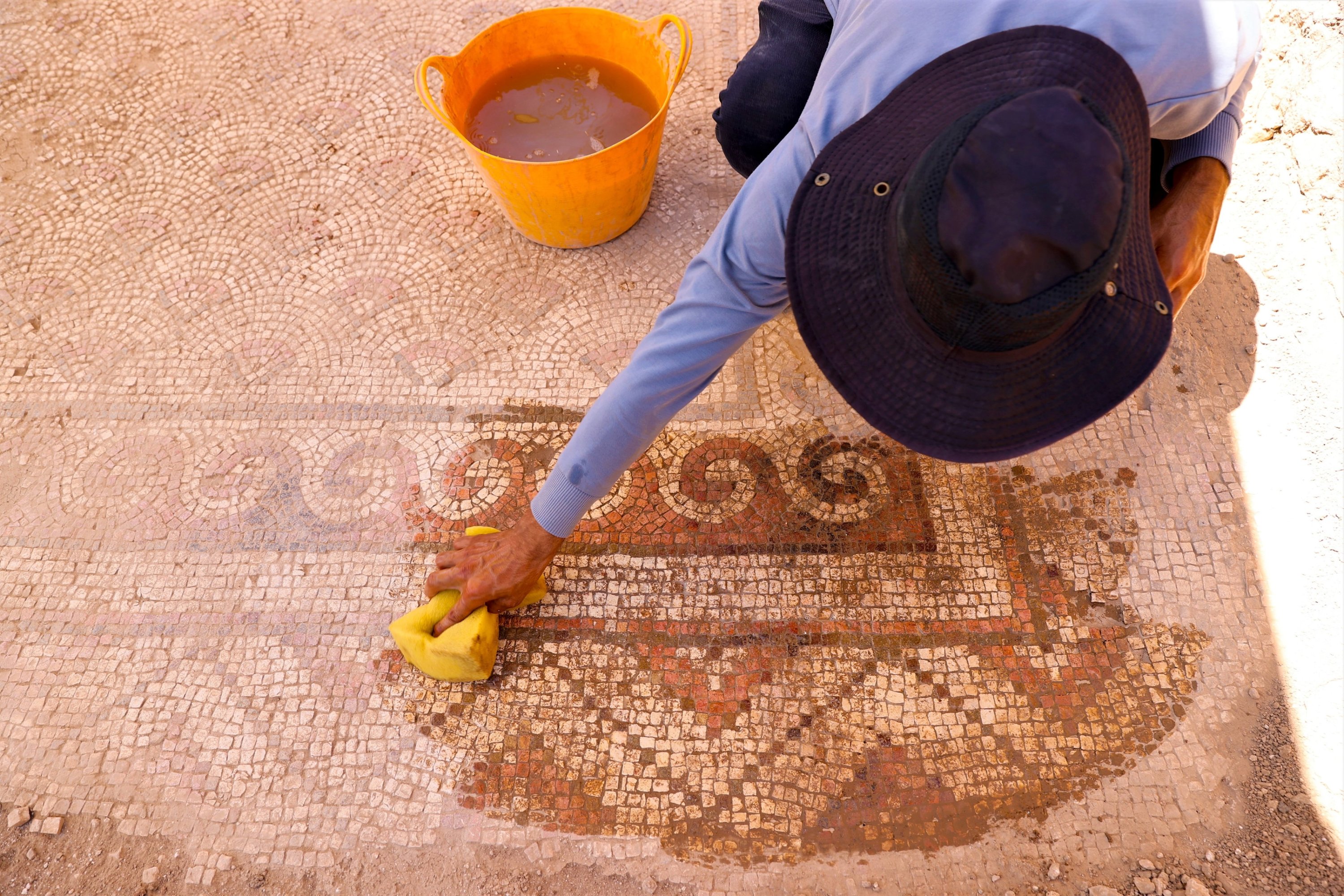 A researcher reveals the mosaic uncovered at the ancient city of Dara, Mardin, southeastern Türkiye, June 25, 2025. (AA Photo)
