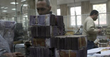 Bundles of Syrian currency notes are stacked up as an employee counts money at Syrian central bank, after the ousting of Bashar Assadö Damascus, Syria, Jan. 12, 2025. (Reuters Photo)