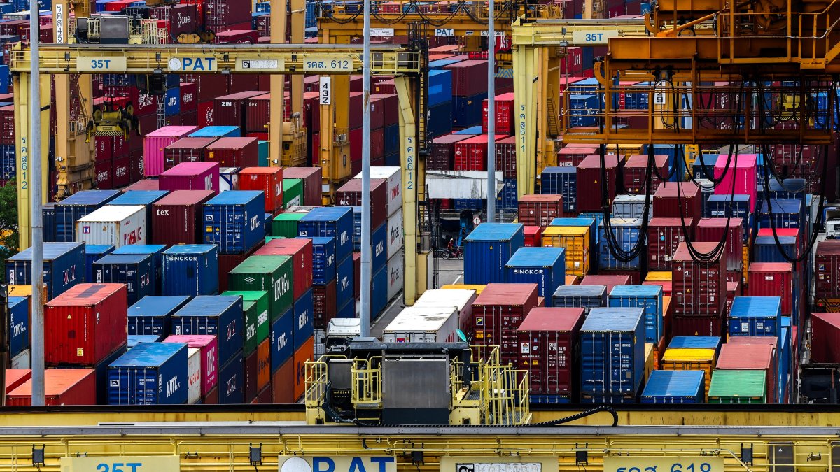A man rides a motorcycle past containers at a port, following the announcement that U.S. President Donald Trump would impose tariffs of 36% on goods from Thailand, Bangkok, Thailand, July 8, 2025. (Reuters Photo)