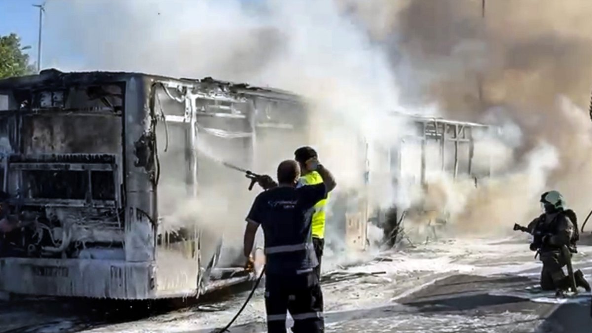 Firefighters and emergency teams work to control the blaze on the burnt metrobus near the Incirli stop in Bakırköy, Istanbul, Türkiye, July 7, 2025. (AA Photo)
