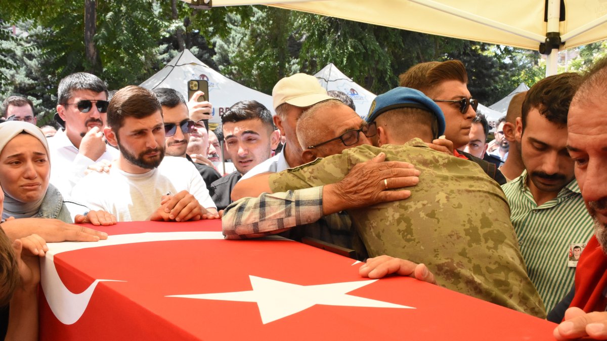 A fellow soldier hugs Ömer Ali Özkanlı, grandfather of Özkan Özkanlı, during the latter&#039;s funeral in Aksaray, central Türkiye, July 8, 2025. (AA Photo)