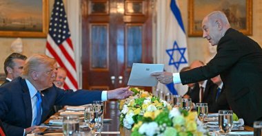 Israeli Prime Minister Benjamin Netanyahu (R) hands over a letter to U.S. President Donald Trump as they meet at the Blue Room of the White House, Washington, U.S., July 7, 2025. (AFP Photo)