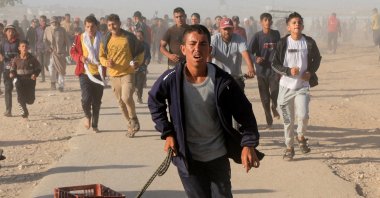 Palestinians walk to collect aid supplies from the U.S.-backed Gaza Humanitarian Foundation, in Khan Younis, in the southern Gaza Strip, Palestine, May 29, 2025. (Reuters Photo)