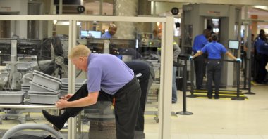 A traveler removes his shoes at Hartsfield-Jackson Atlanta International Airport, Wednesday, Jan. 15, 2014.  (Kent D. Johnson/Atlanta Journal-Constitution via AP, File)