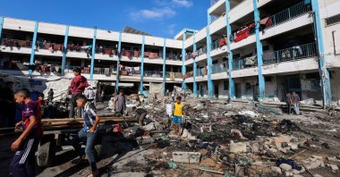 Palestinians inspect the site of an overnight Israeli strike on a school sheltering displaced people, in Bureij refugee camp, in the central Gaza Strip, July 8, 2025. (Reuters Photo)