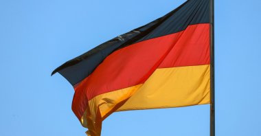 A German flag is seen as the German chancellor and the prime minister of Luxembourg review the honor guard during a welcome ceremony at the Chancellery in Berlin, Germany, 01 July 2025. (EPA Photo)