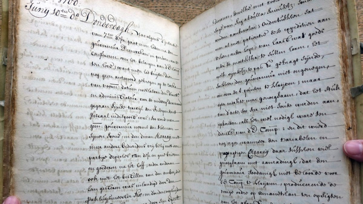 Dutch art detective Arthur Brand holds stolen documents from the 15th to the 19th century, including several UNESCO-listed archives, Amsterdam, Netherlands, July 8, 2025. (AFP Photo)
