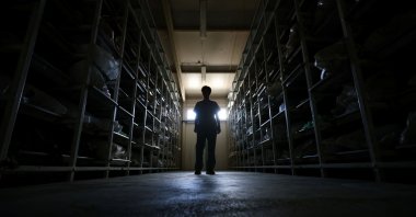 A forensic anthropologist enters a facility where unidentified remains, clothing and personal items exhumed from mass graves are kept, Tuzla, Bosnia-Herzegovina, June 30, 2025. (Reuters Photo)