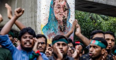Students chant slogans near a vandalized mural of Bangladesh&#039;s ousted Prime Minister Sheikh Hasina, in Dhaka, Bangladesh, Aug. 12, 2024. (AFP Photo)