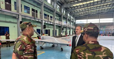 Presidency of Defense Industries head Haluk Görgün (C) inspects a Bayraktar TB2 drone, produced by Turkish defense company Baykar, while chatting with army officials during a visit to Dhaka, Bangladesh, July 8, 2025. (AA Photo)